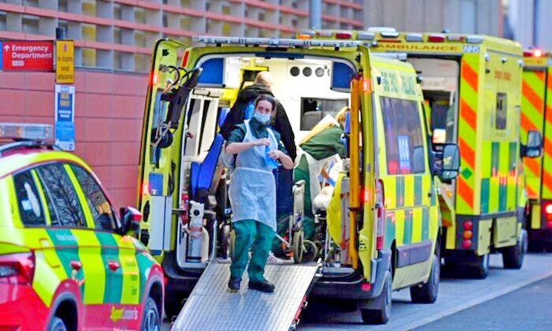 Paramedics work inside an ambulance parked outside the Royal London Hospital in east London on Jan. 7, 2022. (Daniel Leal/AFP via Getty Images)
