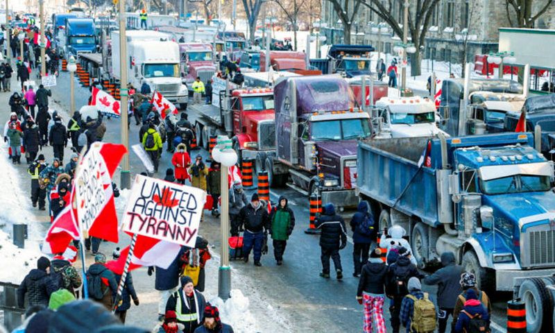 Trucks sit parked on Wellington Street near the Parliament Buildings as truckers and their supporters take part in a convoy to protest COVID-19 vaccine mandates for cross-border truck drivers in Ottawa, Canada, on Jan. 29, 2022. (Patrick Doyle/Reuters)