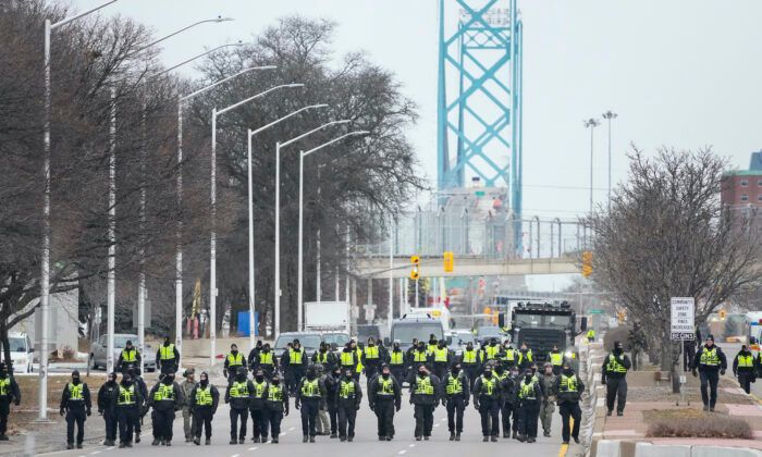 Police arrest protesters near the Ambassador Bridge in Windsor, Canada, on Feb. 13, 2022. (Jeff Kowalsky/AFP via Getty Images)