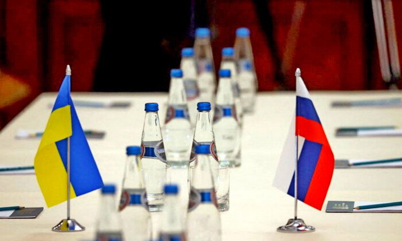 Russian and Ukrainian flags are seen on a table before the talks between officials of the two countries in the Gomel region, Belarus on Feb. 28, 2022. (Sergei Kholodilin/BelTA via Reuters)