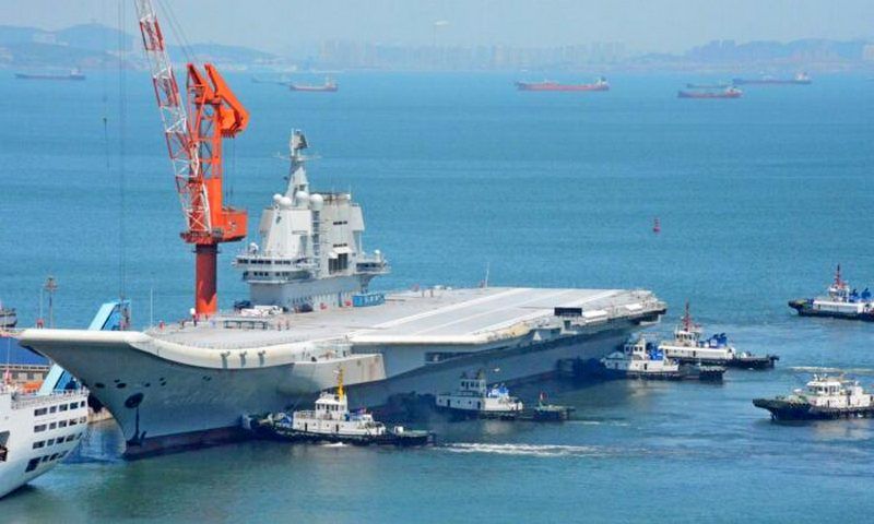 Tugs guide China's first domestically manufactured aircraft carrier, known as "Type 001A," as it returns to port in Dalian in China's northeastern Liaoning province after its first sea trial, on May 18, 2018.  (AFP via Getty Images)