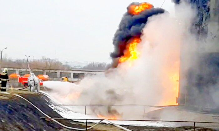 Members of the Russian Emergencies Ministry extinguish a fire at a fuel depot in the city of Belgorod, Russia, on April 1, 2022, in a still from video. (Russian Emergencies Ministry/Handout via Reuters)