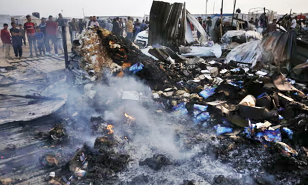 Palestinians observe the destruction caused by an Israeli strike on Rafah.